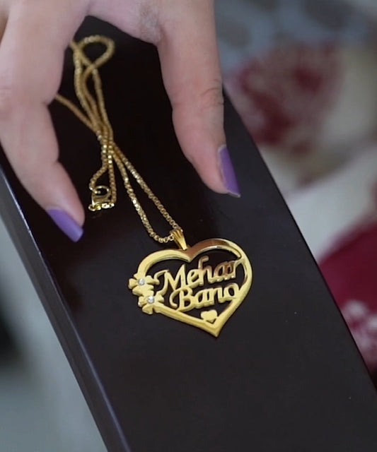 Gold heart-shaped pendant with 'Mehar Band' text on a black box, branded 'mibbilux.com'.