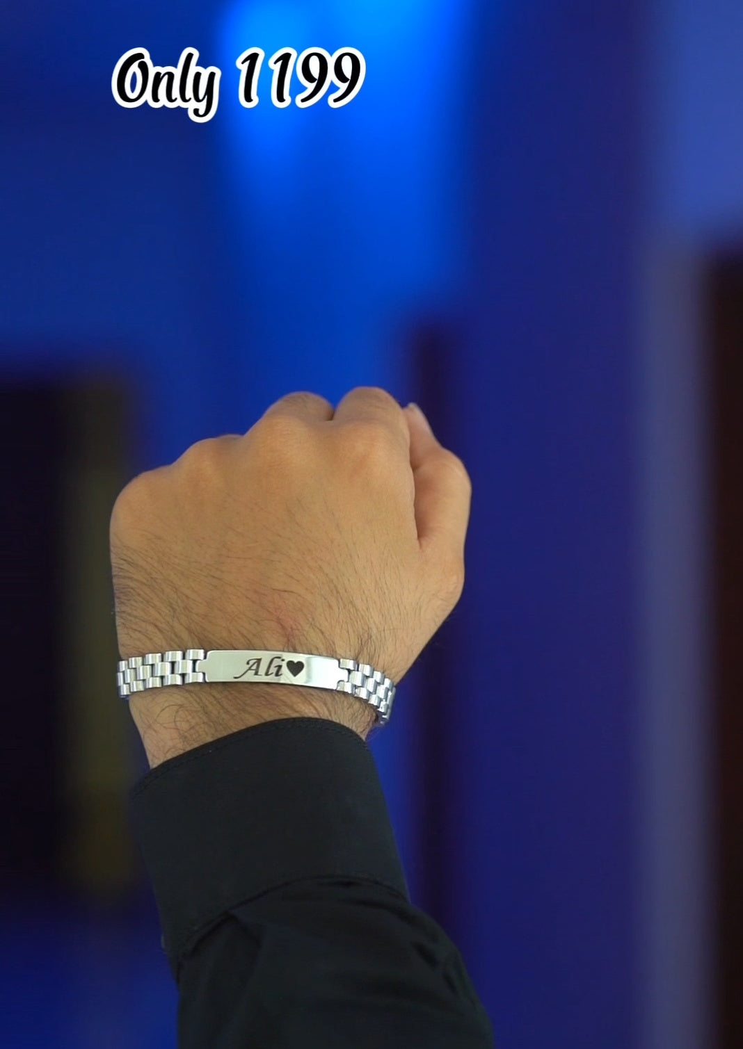 Hand wearing a silver bracelet with text on a blue background