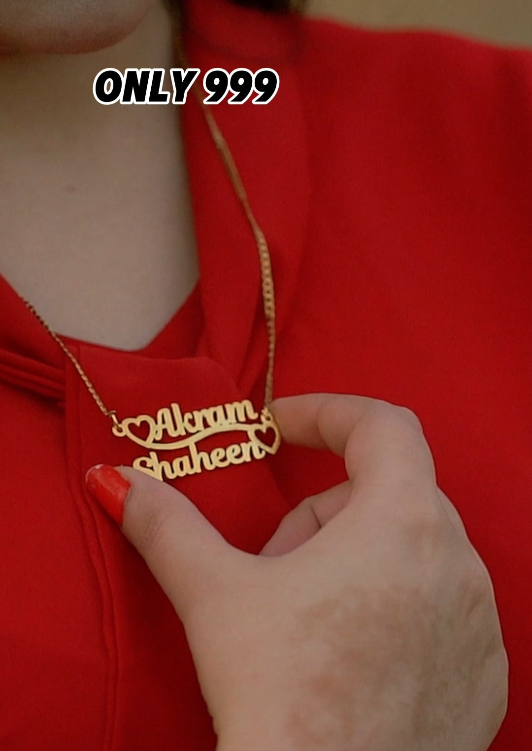 Gold necklace with engraved names on a red background, with text 'ONLY 999' above.